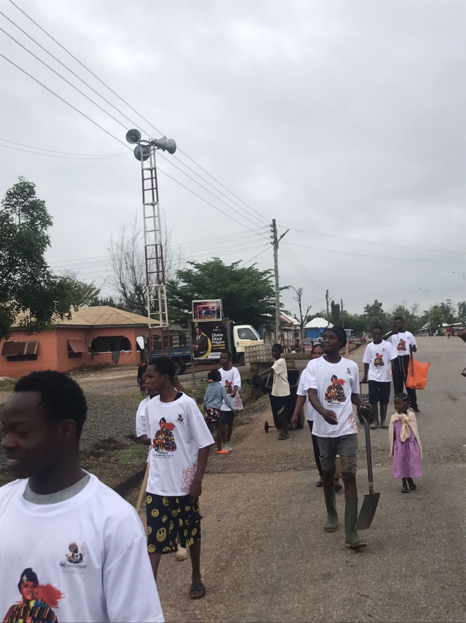 Women volunteers with brooms cleaning Nsuontem streets